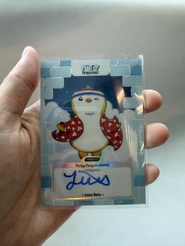 A hand holds a holographic trading card from 'TYPYK Universe' featuring a penguin mascot named 'Loro Keto' wearing a red Hawaiian shirt, with text reading 'Pedag Penguin Abang Edmodo' and a signature.