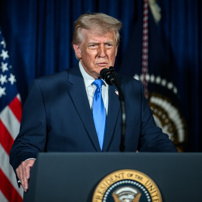 President Trump speaks at a podium adorned with "President of the United States," relating to his declaration of ending the "war on crypto" by terminating Operation Choke Point 2.0.