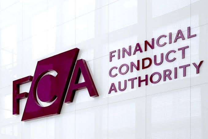 A metallic purple sign mounted on a white tiled wall displays the logo "FCA" alongside the text "FINANCIAL CONDUCT AUTHORITY".