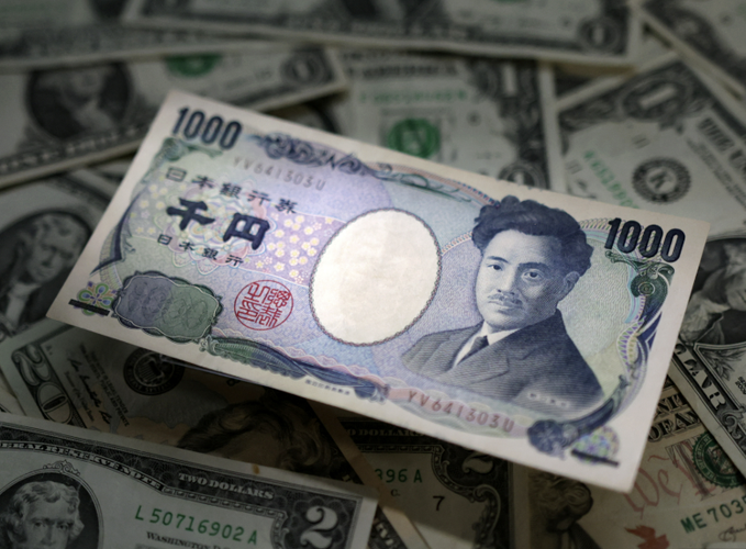 A Japanese 1000 yen banknote featuring the portrait of Natsume Soseki rests on a scattered pile of US one and two dollar bills. The juxtaposition of the yen note against US currency visually represents the foreign exchange market, relevant to XRP which is often used as a bridge currency in cross-border payments between different fiat currencies.