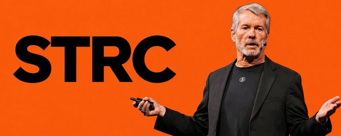 A man in a dark blazer presents with an orange backdrop featuring the bold black text "STRC," visually anchoring the discussion of Strategy's $STRC preferred stock and its recent stress test to $71.