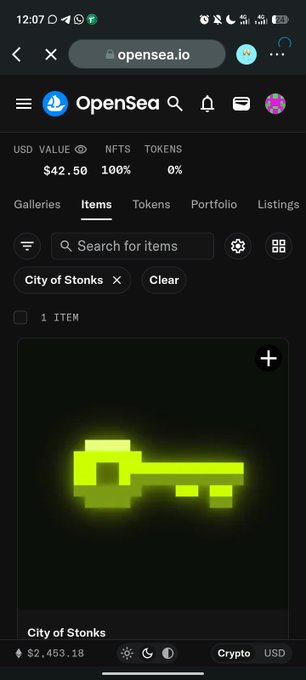 A screenshot of the OpenSea website on a mobile browser displaying an NFT called 'City of Stonks' with a glowing green pixel art key on a black background, priced at $2,453.18.