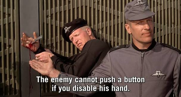 A meme featuring two men in Star Trek-style uniforms back-to-back, one holding a bloody knife, with the caption 'The enemy cannot push a button if you disable his hand.'