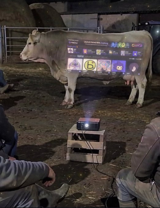 A cow stands in a barn while a small projector on a wooden crate displays a Roblox game selection menu titled "Launch Palsand With Everything" directly onto its side. The post "bullish vibe" humorously plays on the visible cow and the bullish stock market term, with the screen text reinforcing the quirky, internet-culture humor.