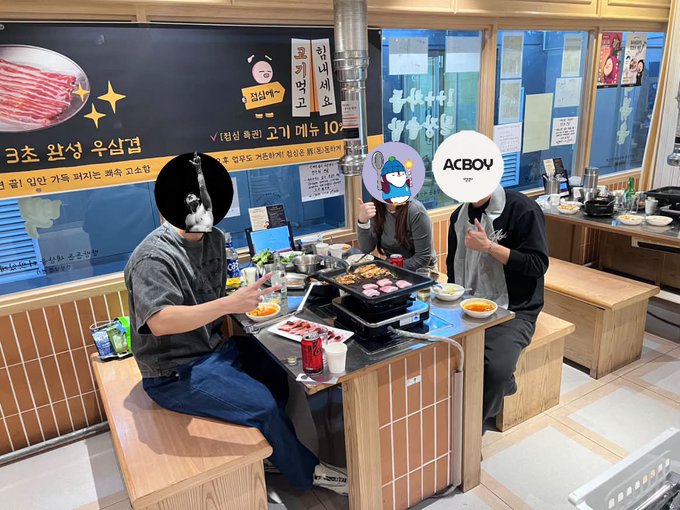 Three people enjoy Korean BBQ at a restaurant with visible signage in Korean promoting "고기 베누 10%" (a meat discount) and "크소 활생 우심급" along with an "ACBOY" logo, fitting the post's warm, welcoming spirit as Betty meets friends in Seoul during the Korea Blockchain Week festivities.