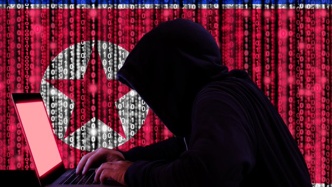 A hooded figure types on a laptop against a backdrop of cascading red binary code and a digital radiation symbol, visually representing the covert and malicious nature of North Korean hackers leveraging AI for sophisticated cyberattacks on crypto and financial firms.