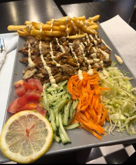The image shows a plate of food, including a variety of vegetables such as carrots, tomatoes, cucumbers, and lettuce, along with some meat and fries. The dish appears to be a healthy meal option that could be enjoyed by many people. The post is promoting a giveaway where people can win lunch for four friends in exchange for sharing their own lunch on social media using the hashtag #lunchfor4friends. This encourages people to share their meals, spread positivity and support each other during these challenging times.