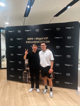 Two men pose with peace signs in front of a step-and-repeat backdrop reading "AWS x Bitget VIP EXCLUSIVE SALON," reflecting the post's account of attending a Pi KYB enterprise banquet hosted by Bitget, where the author networked and gained insights on RWA (real-world asset) tokenization.