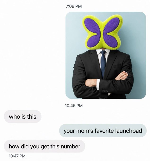A screenshot of a chat conversation where a user sends a photo of a businessman with a purple and yellow butterfly pillow covering his face, responds "who is this" and "how did you get this number," to which the sender jokes "your mom's favorite launchpad." The image humorously pairs with the $FLAPGUY token post, playing on the "flap" and "launchpad" puns.