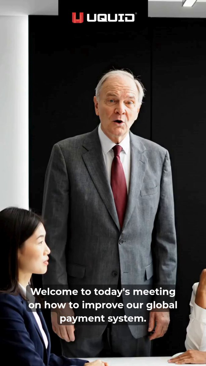 The image shows an older man wearing a suit standing next to two women who are sitting down. The text "Welcome to today's meeting on how to improve our global payment system." is displayed, indicating that they are discussing ways to enhance their payment system.