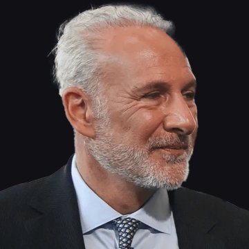 The image features a man wearing a suit, tie, and white shirt with gray hair. He has a beard and mustache, giving him an older appearance. The background of the image is black, which contrasts with his white hair. There are also some text elements in the image that read "PETER SCHIFF PREDICTED TETHER'S MARKET CAP WILL SURPASSETHERE AND BITCOIN." This suggests that Peter Schiff's predictions about the market cap of cryptocurrency andetherium might be accurate, as he is a well-known financial expert.

The man in the image appears to be looking off into the distance or deep thoughtfully, possibly contemplating the future of the markets or making investment decisions based on his forecasts.