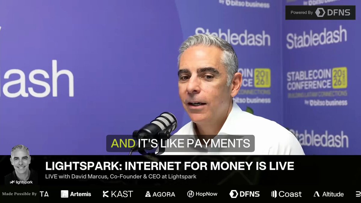 The image features a man sitting at a microphone during an event or conference. The background of the image shows a blue banner with white text, which reads "And it's like payments businesses are like slingshots, and he has spent four years pulling one back at @lightspark". This phrase is attributed to David Marcus, the founder of the company Instagram. The man speaking into the microphone is identified as David Marcus, who is also known for his role in founding Instagram.