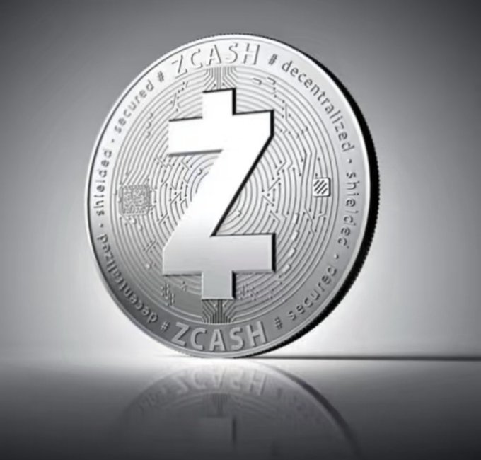 A silver Zcash cryptocurrency coin with the text 'ZCASH', 'decentralized', and 'secure' engraved on it.
