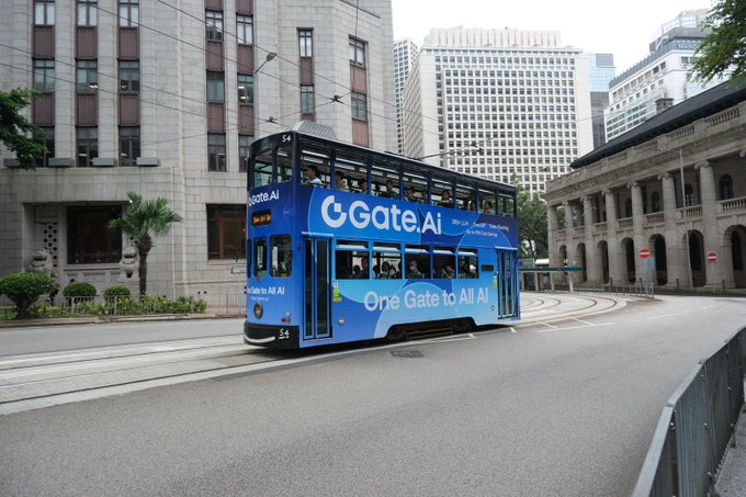 A blue double-decker tram on city tracks displaying 'Gate.AI' and 'One Gate to All AI' advertising, set against a backdrop of classical and modern buildings.