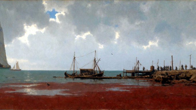 A serene coastal scene depicts fishing boats moored along a reddish shoreline with figures gathered on a pier to the right, under a dramatic cloudy sky pierced by rays of light. The tranquil maritime tableau mirrors the NFT's "Mild Suffering" mood and slight 2.54% price dip, evoking the quiet resilience of a harbor weathering a passing storm.