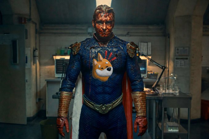 A bloodied figure in a blue superhero costume with a red cape and gold accents stands in what appears to be a dimly lit laboratory or industrial setting, with a cartoon doge emoji digitally added over the chest emblem. The battered, battle-worn superhero imagery serves as a visual metaphor for the post's message about the $BONK community standing resilient and bloodied but undefeated amid separate concerns over DAO treasury governance versus the token itself.
