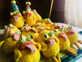 A plate of cute, chick-shaped deviled eggs decorated with small faces and details, presented as an Easter or spring-themed appetizer.
