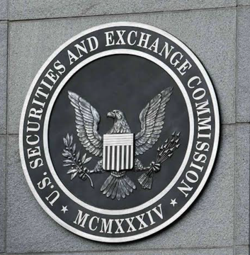 The image shows the official seal of the U.S. Securities and Exchange Commission (SEC), featuring a bald eagle and the inscription "SECURITIES AND EXCHANGE COMMISSION" with the Roman numerals "MCMXXXIV" (1934). The seal relates to the post by visually representing the SEC, whose outdated NMS rules the Blockchain Association is supporting efforts to modernize to better accommodate tokenization technology.