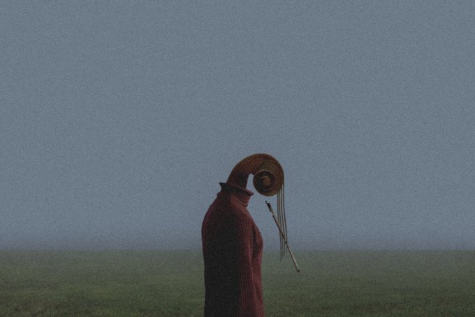A solitary figure in a red cloak and wide-brimmed hat stands in a misty field, their head bowed as if in deep contemplation. The muted, atmospheric scene evokes a sense of quiet introspection, mirroring the contemplative tone of the accompanying post about a new drop titled "The Voice of the Mind" priced at 1.00Ξ on SR.
