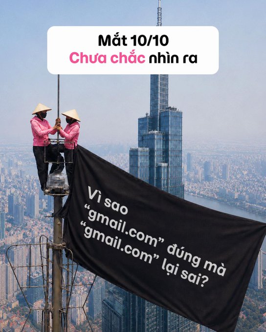 Two workers in pink shirts and conical hats hang a black banner on a tall building, with Vietnamese text asking 'Mắt 10/10 Chưa chắc nhìn ra' and 'Vì sao "gmail.com" đúng mà "gmail.com" lại sai?'