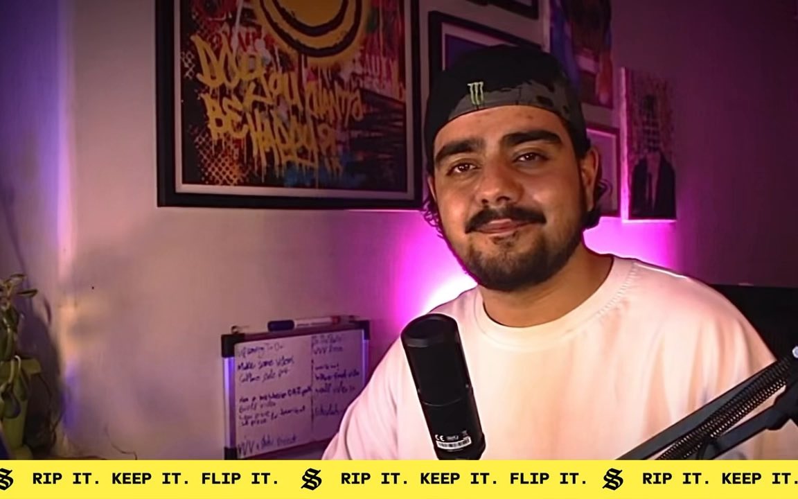 A man wearing a Monster Energy cap speaks into a microphone, with a banner at the bottom reading 'RIP IT. KEEP IT. FLIP IT.'