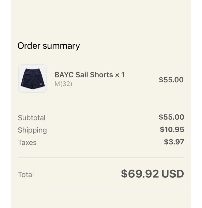 An order summary screen showing BAYC Sail Shorts in size M (32) priced at $55.00, with $10.95 shipping and $3.97 taxes, totaling $69.92 USD.