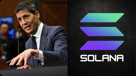 The image features a man wearing a suit standing behind a podium at a conference or event. The man appears to be giving a speech, as he is holding a microphone up to his mouth. In front of him, there's an advertisement for Solana cryptocurrency, which has a logo featuring the word "SOLANA" in blue and purple colors. This suggests that the image might have been taken at or near a Solana event, where the man is speaking about the benefits of investing in this particular cryptocurrency.
