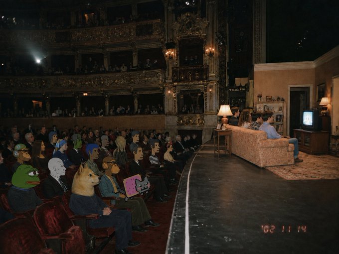 The image shows a group of people sitting in front of an audience, with some of them wearing animal masks as part of their costumes for a performance or event. The audience appears to be watching a show or movie that has been edited to include these animal characters. The scene takes place on stage, and the audience is seated on red chairs while the performers are standing behind them. A couch can also be seen in the background. The post seems to be related to this event as it contains information about an unintentionally directed video, possibly featuring a performance or show with animal masks.