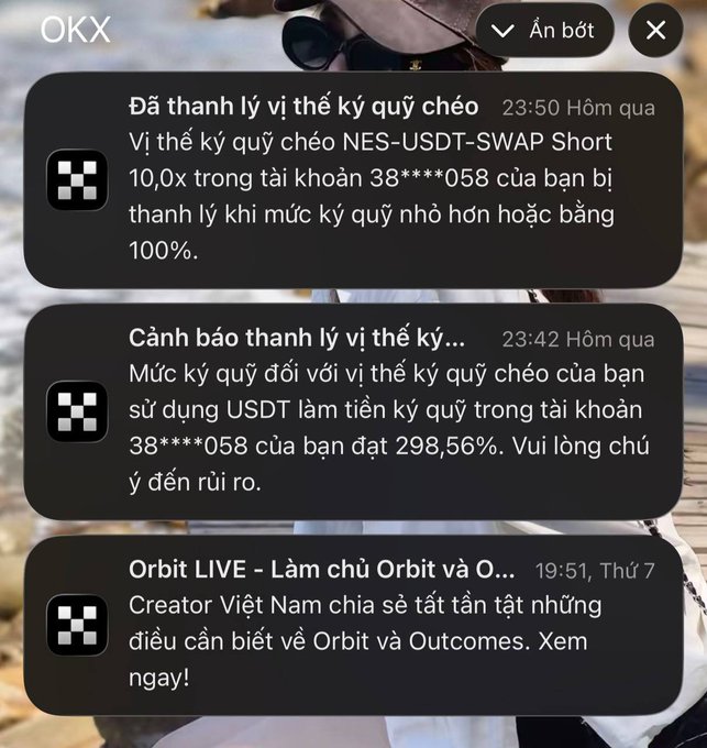 A Vietnamese-language OKX exchange notification screen showing three alerts: a futures position liquidation for NES-USDT-SWAP Short 10x, a margin warning indicating the position reached 298.56% margin ratio, and an Orbit LIVE promotional message.