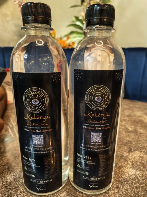 Two bottles of branded water from Kalonji Restaurant featuring a black label with a QR code, contact numbers (01330-933133, 01810-337722), and 'Where Taste Meets Memories' tagline, priced at 20 Tk each.