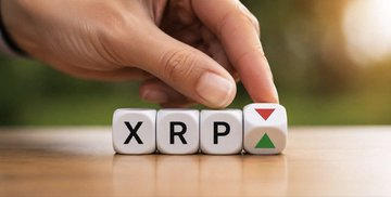 The image features a hand pointing at a white cube with "XRP" written on it, which is part of a larger arrangement of cubes containing different letters such as "x", "r", "p", and "y". The arrangement appears to be a creative way to represent the concept of investing in cryptocurrency.