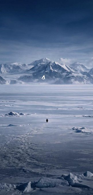 A solitary figure treks across a vast, frozen expanse toward distant snow-capped mountains, embodying the journey of overcoming hardships to reach greater heights—much like the Latin phrase "Per aspera ad astra" (through hardships to the stars). The endless icy wilderness and towering peaks in the distance symbolize the perseverance required to rise above adversity.