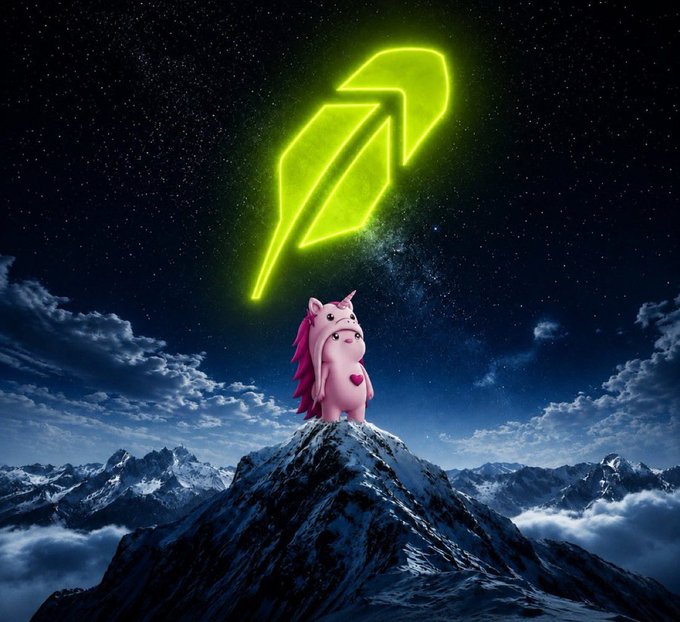 A pink unicorn-like character stands atop a snowy mountain peak beneath a starry night sky, with a glowing green quill/feather symbol floating above it—evoking the idea of an early, promising discovery reaching new heights. The imagery aligns with the post's theme of $SWAPPY being a freshly noted watchlist gem, signaling potential upward momentum and rising attention.