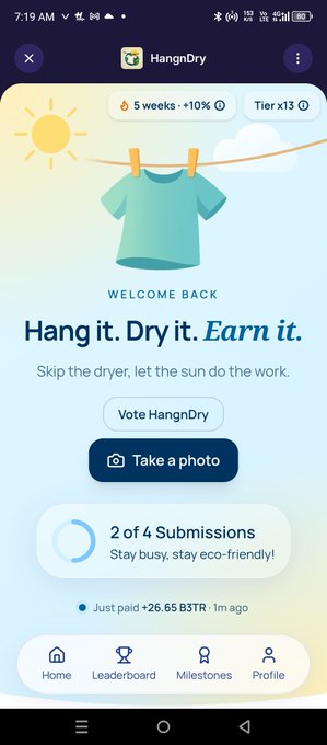 A mobile app screenshot for 'HangnDry' showing the tagline 'Hang it. Dry it. Earn it.' with a t-shirt on a clothesline illustration, a 'Vote HangnDry' button, 'Take a photo' option, and progress showing '2 of 4 Submissions'.