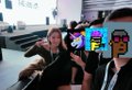 A blurry thumbnail of a video showing people at an event, with colorful emojis overlaid on the image.