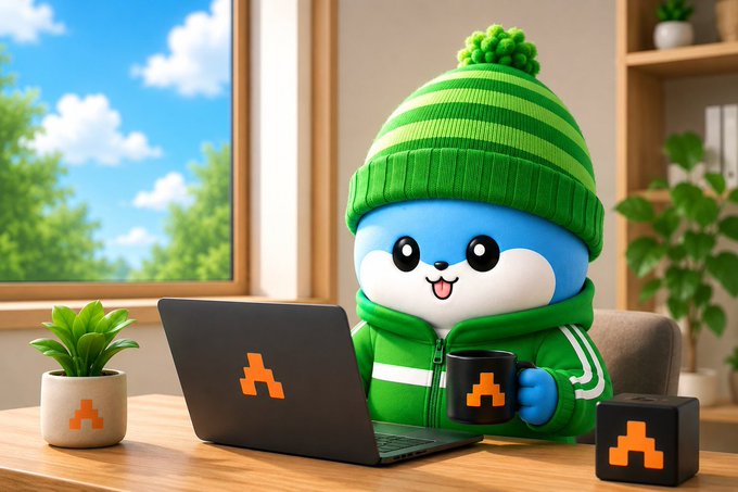 A cheerful blue cartoon character wearing a green striped beanie and tracksuit works on a laptop and sips coffee at a cozy desk, with an orange "A" logo displayed on the laptop, mug, and a nearby box—matching the ARC Terminal branding referenced in the post about AI control and trust. The cozy, focused workspace visually reinforces the post's message about the next AI shift being centered on ownership and execution rather than just model intelligence.