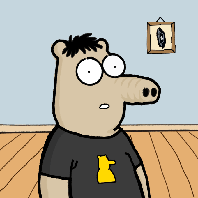 A cartoon illustration of a wide-eyed anthropomorphic character with a long nose wearing a black t-shirt with a yellow figure on it, with a framed picture on the wall behind.