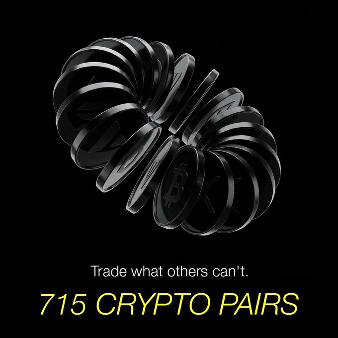A promotional advertisement featuring stacks of cryptocurrency coins (including Bitcoin) against a black background, with the text 'Trade what others can't.' and '715 CRYPTO PAIRS' in yellow.
