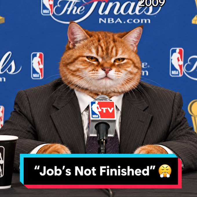 An AI-generated orange cat in a pinstripe suit sits at an NBA Finals press conference, with text reading "Job's Not Finished" and "2009 NBA Finals NBA.com".