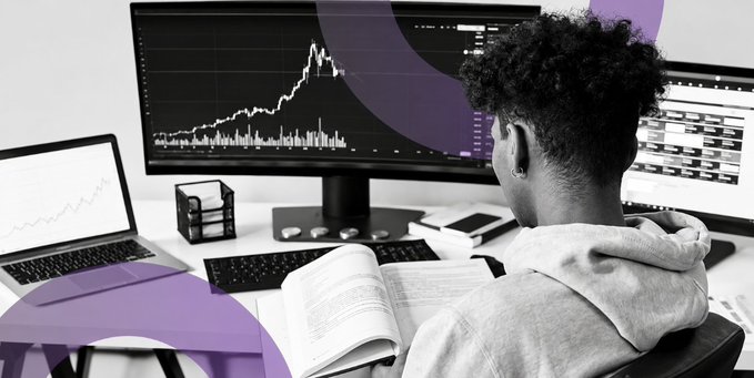 A person sits at a desk viewing stock market charts on multiple monitors with purple design overlays.