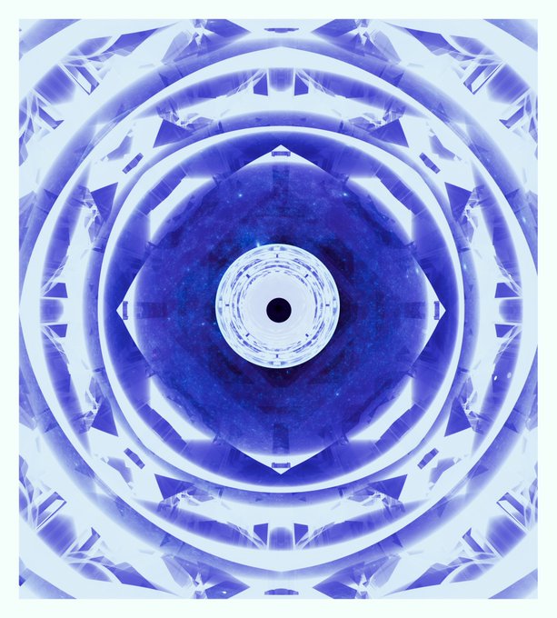 A symmetrical, kaleidoscopic mandala-style design featuring concentric circular patterns in shades of blue and white, resembling a crystal or lens structure with a dark center.