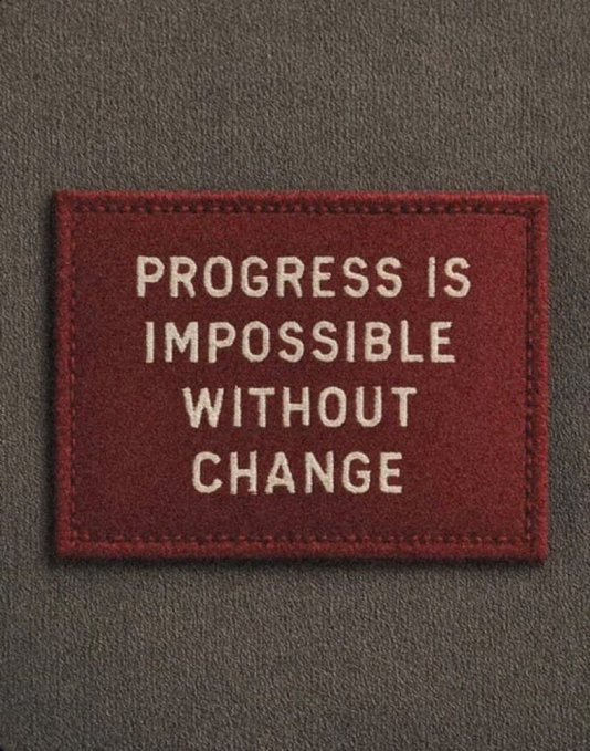 A red fabric patch with white embroidered text reading 'PROGRESS IS IMPOSSIBLE WITHOUT CHANGE' attached to a gray surface.