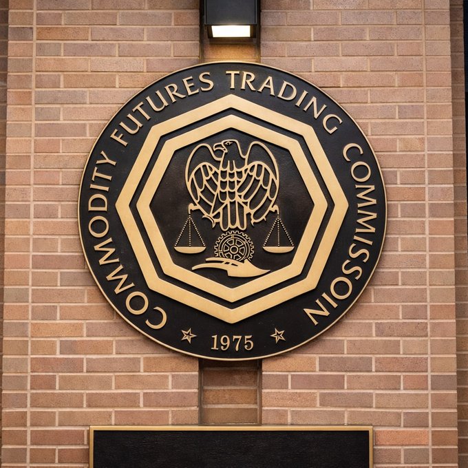 The official bronze and black seal of the Commodity Futures Trading Commission, dated 1975, mounted on a brick wall.