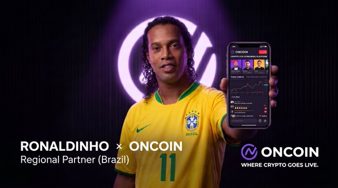 Brazilian football legend Ronaldinho, wearing his iconic #11 Brazil jersey, is shown as the new Regional Partner for OnCoin, holding up a smartphone displaying the crypto app's streaming platform, with text reading "RONALDINHO × ONCOIN Regional Partner (Brazil)" and the tagline "WHERE CRYPTO GOES LIVE."