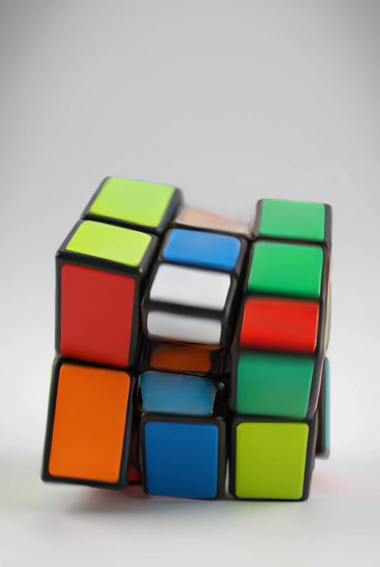 The image features a Rubik's cube with its sides facing different directions, creating an interesting visual effect. The cube has multiple colors - red, green, blue, yellow, orange, and black. It appears that someone has taken a photo of this unique Rubik's cube, possibly to share it on social media or for educational purposes.