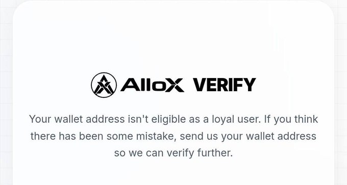 A notification card with the AlloX VERIFY logo stating 'Your wallet address isn't eligible as a loyal user. If you think there has been some mistake, send us your wallet address so we can verify further.'