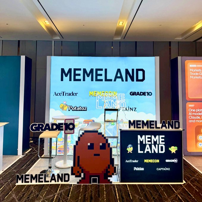 A vibrant MEMELAND booth display at KBW 2026 features branding for $MEME, Memecoin, Potatoz, and Captainz, along with a pixel-art mascot and signage promoting AceTrader and GRADE10 partnerships. The setup, complete with branded furniture and screens, visually promotes the memecoin ecosystem to attendees during the September 30–October 1 event in Seoul.