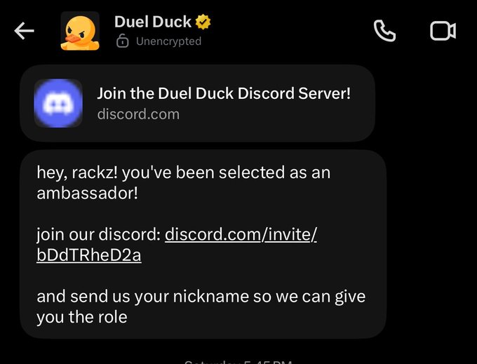 A screenshot of an SMS conversation inviting the user 'rackz' to join the Duel Duck Discord server as an ambassador, with a link to discord.com/invite/bDdTRheD2a.