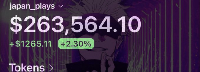 A screenshot showing a crypto portfolio or stock display with username 'japan_plays' showing a balance of '$263,564.10', a gain of '+$1265.11 (+2.30%)' with a 'Tokens' link, overlaid on an anime character background.