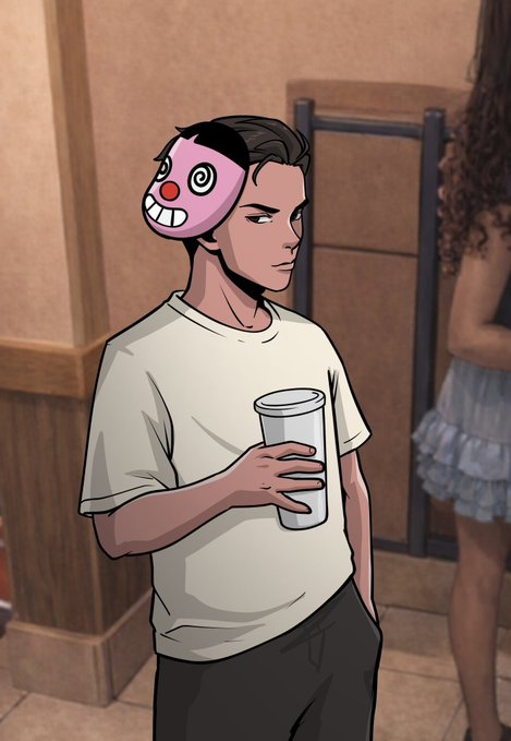 A young man wearing a cartoon clown mask pushed up on his forehead holds a cup in an indoor setting, while a woman stands nearby in a skirt. The image's theme of hidden identity behind a facade mirrors the post's critique of people pretending to have influence in crypto while settling for "crumbs" of attention rather than genuinely thriving.